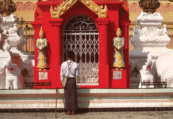 Man standing before a Temple in Burma